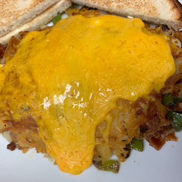 Cheesy hash browns with green peppers and onions, served with toast at Country Ham N' Eggs.